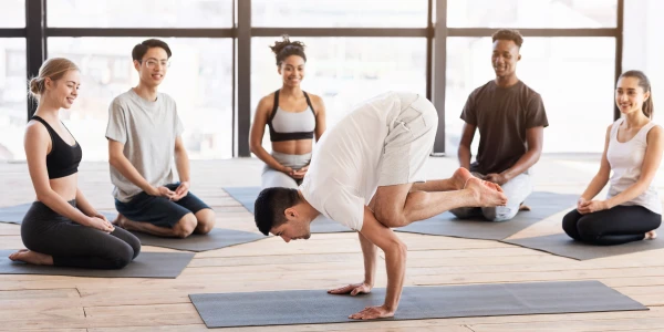 A man practicing yoga in a bright room, symbolizing inner strength and self-discovery for all ages