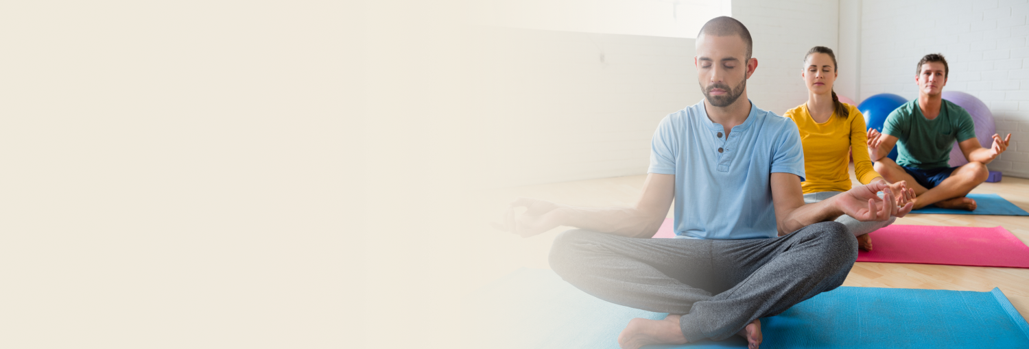 Group of women meditating outdoors in sunlight for wellness
